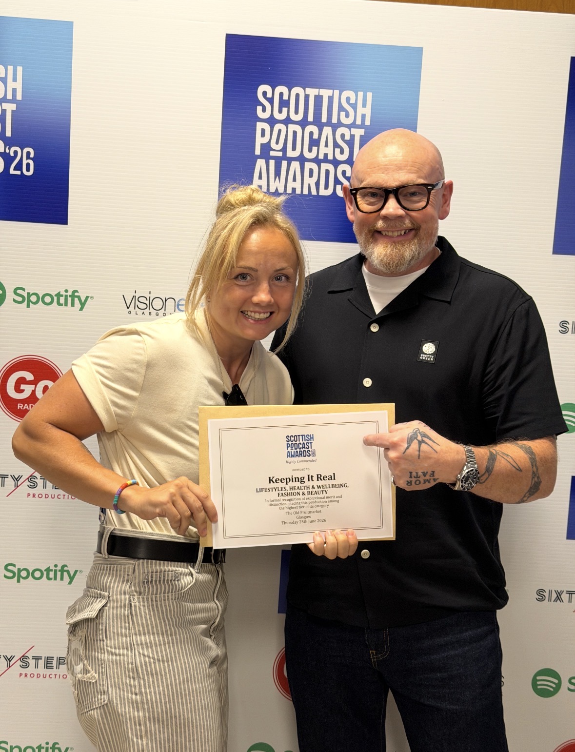 KP holding the Highly Commended certificate for Keeping It Real at the Scottish Podcast Awards 2026