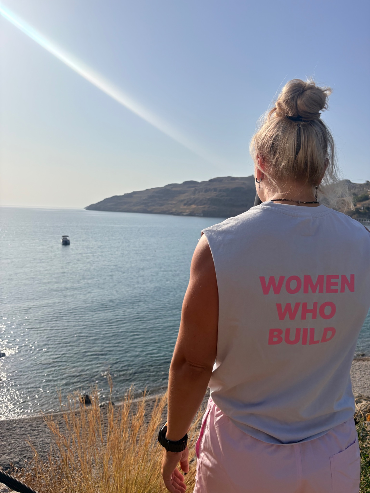 KP overlooking a coastal bay in a Women Who Build top